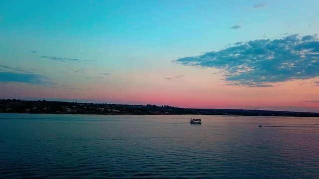 Aerial shot slow descending over Lake Paranoa at dusk