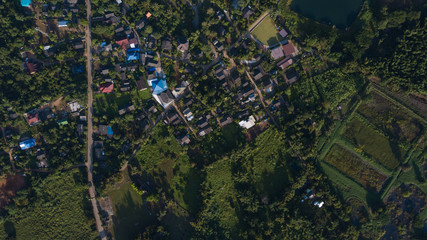 Aerial top view top view of the road through the trees,