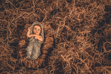 Baby Jesus laying in a manger Christmas background