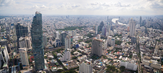 Naklejka premium Clear Sky Over Sathorn District And Chao Phraya River In Bangkok, Thailand, Aerial Panorama Shot