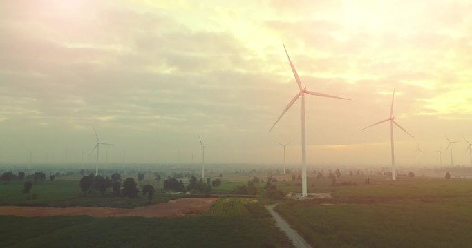 4K Aerial view of Wind turbines farm in the green field,  One of the cleanest, renewable electric energy source.Future sustainable power.Blue sky with corn field location,THAILAND