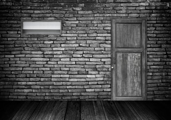 The brick wall interior and the wooden closed door