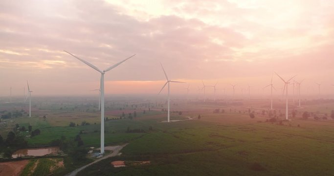 4K Aerial view of Wind turbines farm in the green field,  One of the cleanest, renewable electric energy source.Future sustainable power.Blue sky with corn field location,THAILAND
