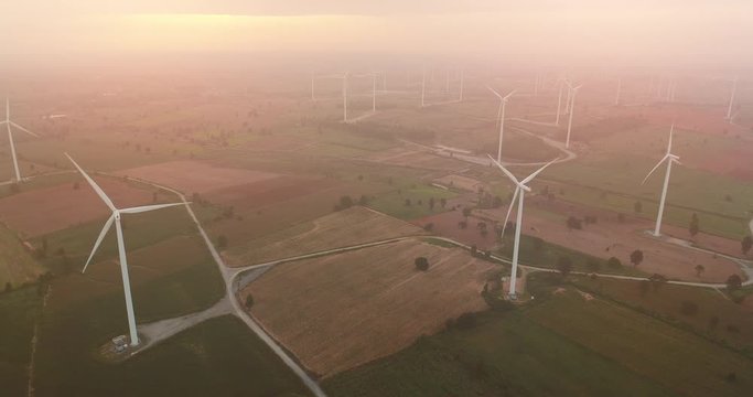 4K Aerial view of Wind turbines farm in the green field,  One of the cleanest, renewable electric energy source.Future sustainable power.Blue sky with corn field location,THAILAND