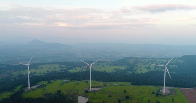 4K Aerial view of Wind turbines farm in the green field,  One of the cleanest, renewable electric energy source.Future sustainable power.Blue sky with corn field location,THAILAND