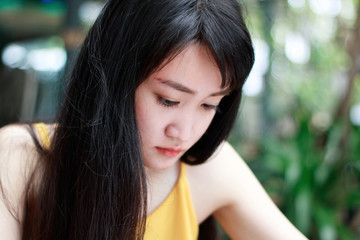 Obraz premium Close up of young Asian woman with blur background.