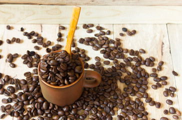 Coffee cup and coffee beans  on wooden background