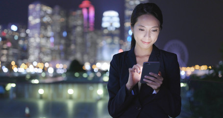 Fototapeta premium Business woman use of mobile phone in Hong Kong city