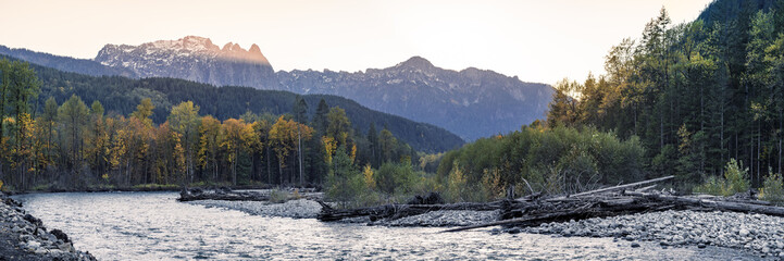 Pacific Northwest Fall Season Landscape of Mountain River and Autumn Color Trees © openrangestock