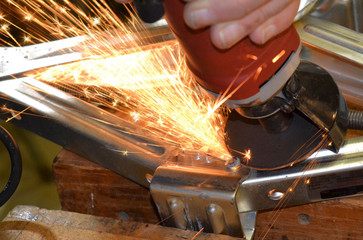 Sparks fly from a metal grinder