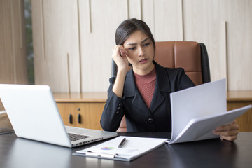 Asian woman working  hard with serious emotion at office, woman working hard concept.