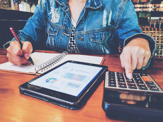 casual business woman or female accountant or banker making calculations. Savings. College student girl doing finances and calculate or checklist product plan and paperwork about cost on company.