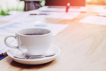 Coffee cup with smoke,work desk with laptop and graph,out side