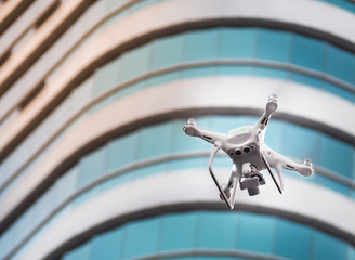 Drone with high resolution digital camera flying in the city. With place your text.