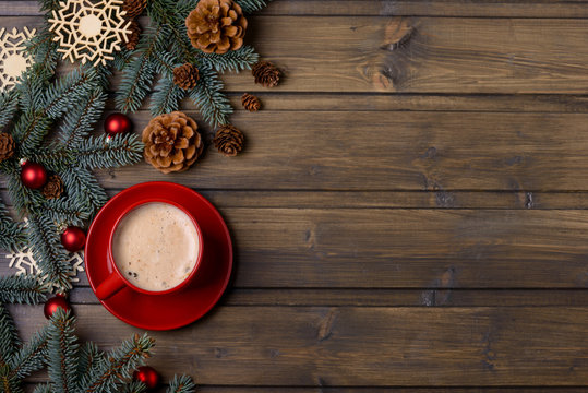 Red cup with coffee and Christmas decoration