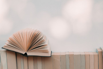 Open book and books on the shelf