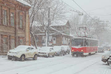 Tram in a snowstorm on a city street