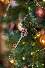 Wooden toy key on Christmas tree. Close-up