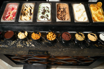 Different kinds of colorful fruit ice cream in boxes