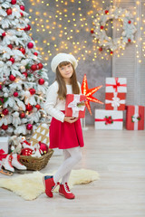 Christmas Family together cellebrating holiday New Year daughter and mother close to white xmas tree with snow and red balls toys