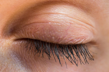 Detailed view of closed eye of woman