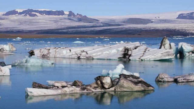 Fantastic view of floating icebergs in the glacial lake Jokulsarlon on the background of clear blue sky, Iceland
