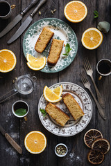 Orange cake served on vintage plate on rustic wooden table background. Food still life. Top view, vertical composition