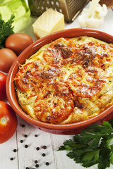 Cauliflower baked with tomato, cheese and eggs
