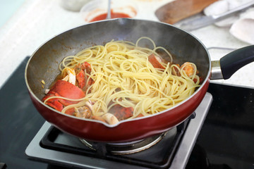 Lobster seafood pasta cooking in a pan