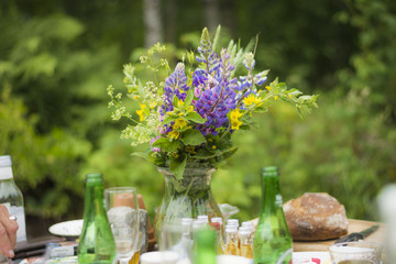 Colorful flowers on a typical Swedish midsummer table.   