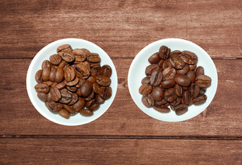 variety of tea in strands and coffee beans on rustic wooden background