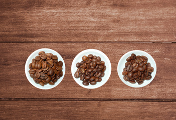 variety of tea in strands and coffee beans on rustic wooden background