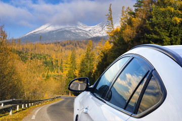 Fototapeta na wymiar White SUV driving the mountain road