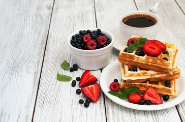 waffles with strawberries,  blueberry and coffee