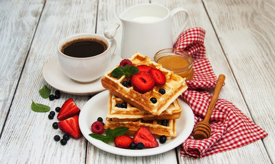 waffles with strawberries,  blueberry and coffee