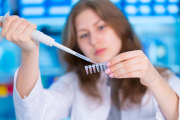 laboratory female assistant with pipette