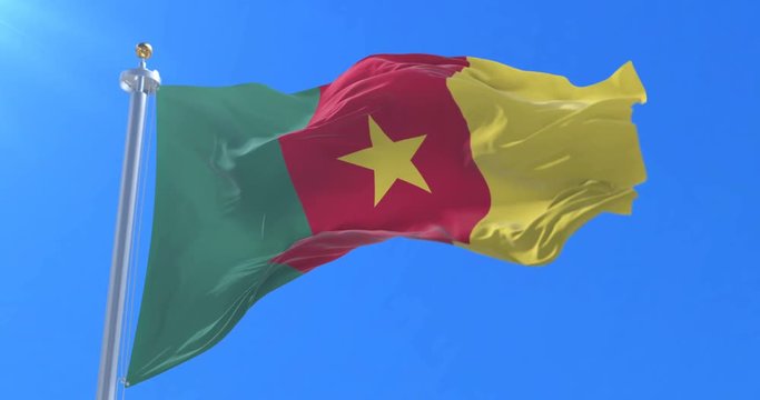 Cameroonian flag waving at wind in slow with blue sky, loop