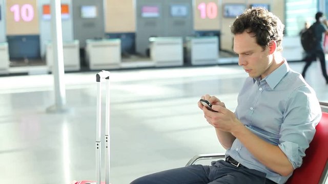 business man passenger using smartphone in the airport