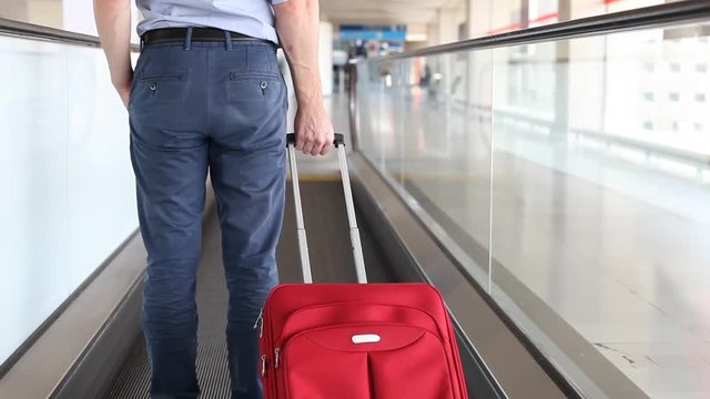 passenger with suitcase luggage on travelator in airport