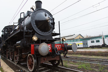 Cremona - November 12, 2017: Historical steam train from Milan to Cremona arriving at the station. Cremona, Italy.