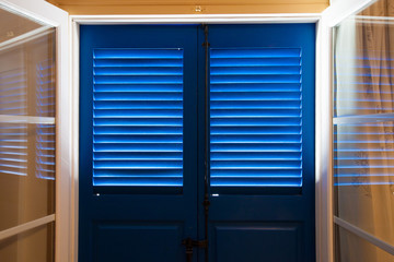 Blue door and window  with shutters