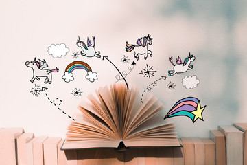 A fairy tales open book with unicorn and rainbow illustration doodles- imagination concept