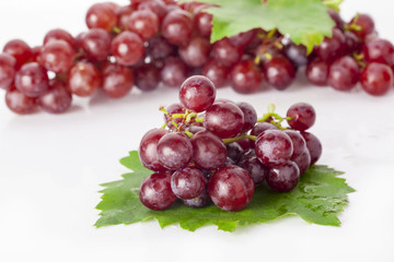 Red grape with leaf isolated on white background