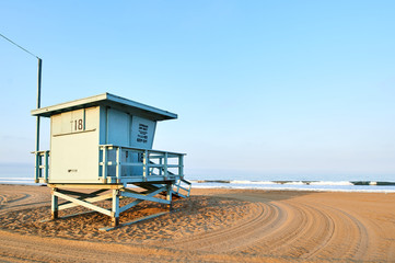 Fototapeta na wymiar Lifeguard booth on Santa Monica beach, Los Angeles, California at sunrise