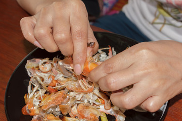 Customers peeled shrimp to eat.
