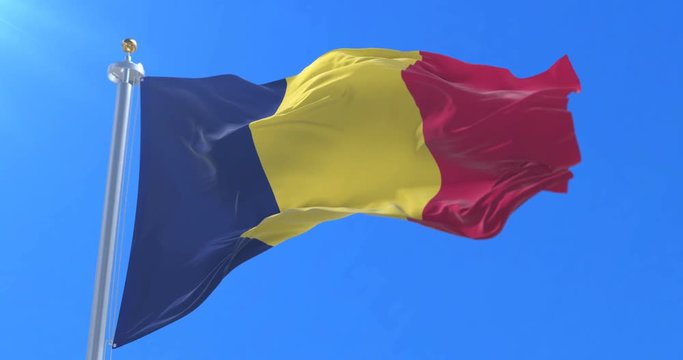 Flag of the Republic of Chad waving at wind with blue sky, loop