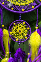 Fototapeta na wymiar Handmade dream catcher with feathers threads and beads rope hanging