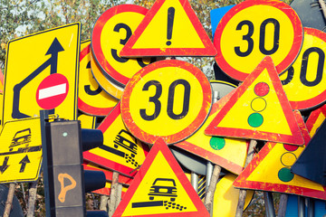 Many industrial road signs stacked together
