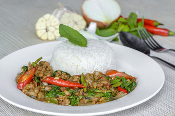 Stir-fried with minced pork and basil on white plate (Pad Ka Prao Moo)