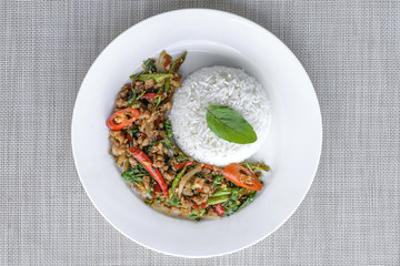 Stir-fried with minced pork and basil on white plate (Pad Ka Prao Moo)